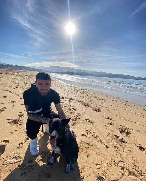 Javi Galán posa en la playa con su mascota.