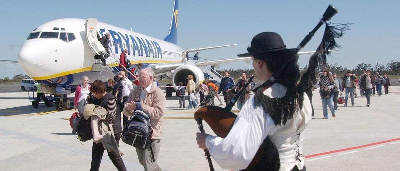 Un gaiteiro recibe en la pista a los pasajeros de un vuelo de Ryanair en el Aeropuerto de Santiago-Rosalía de Castro en una imagen de archivo