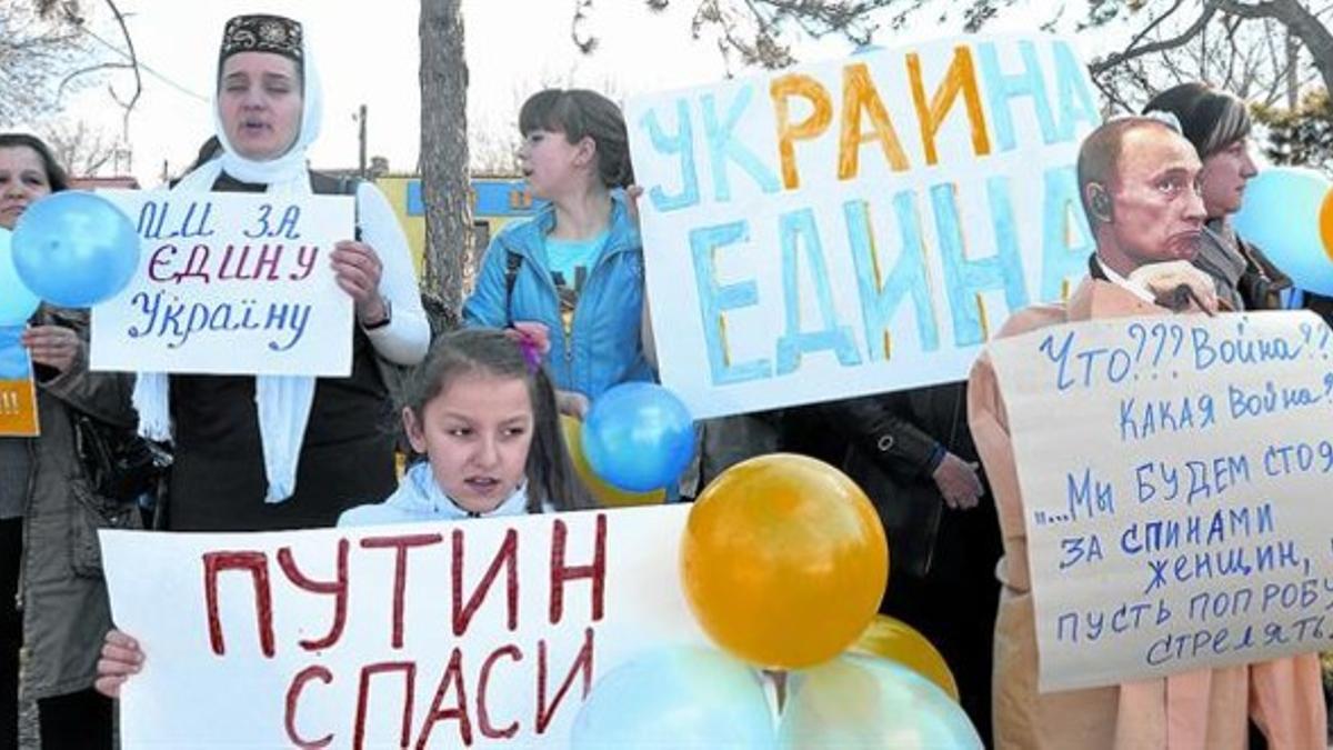 Protesta 8 Mujeres tártaras y ucranianas protestan ante un edificio ocupado por paramilitares prorusos en el pueblo de Bajchisarái, en Crimea.
