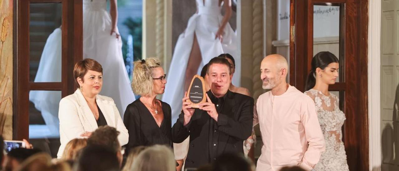 Hannibal Laguna, junto a su hermana, Isabel Angulo, recibe la placa de manos de Modesto Lomba.