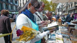 Compradores en un puesto de la Rambla, durante el día de Sant Jordi.