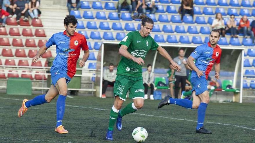 El jugador del Covadonga Jandro conduce el balón entre los azulgranas De la Nava, izquierda, y Turzo.