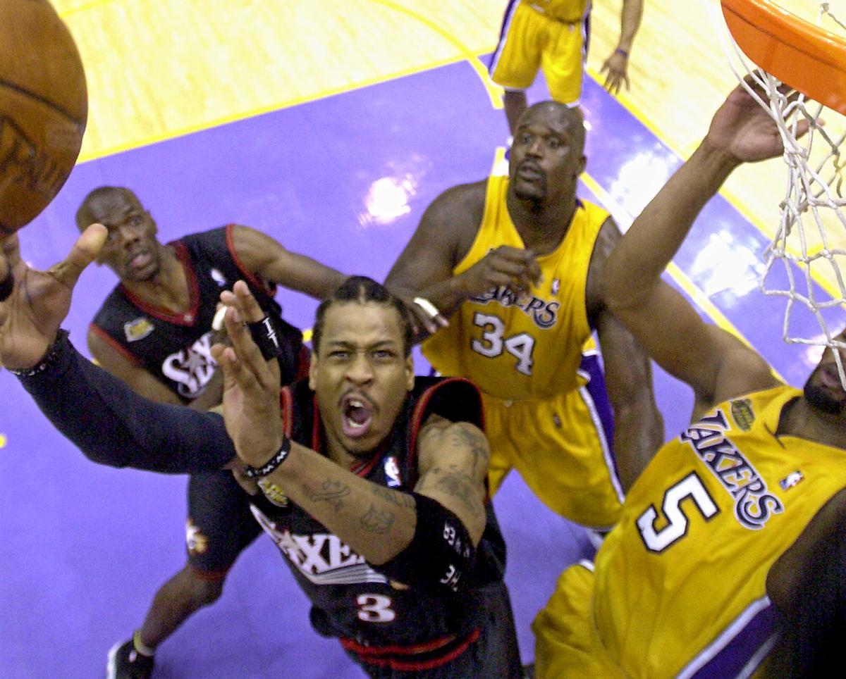 Philadelphia 76ers' Allen Iverson (3) drives to the basket against Los Angeles Lakers defenders Robert Horry, right, and Shaquille O'Neal, center, in the third quarter of Game 2 of the NBA Finals in Los Angeles, Friday, June 8, 2001. Philadelphia's Tyrone Hill looks on at left rear. The Lakers won the game 98-89. (AP Photo/Mark J. Terrill). deportiva accion 2000/2001 _ horizontal