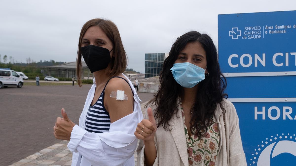 Two young people greet after being vaccinated against Covid-19. Two young people greet after being vaccinated against Covid-19.