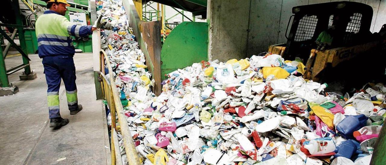 Un operario del Cetra de Fontcalent vigila un depósito de plásticos y envases procedentes de los cubos de basura mezclada.