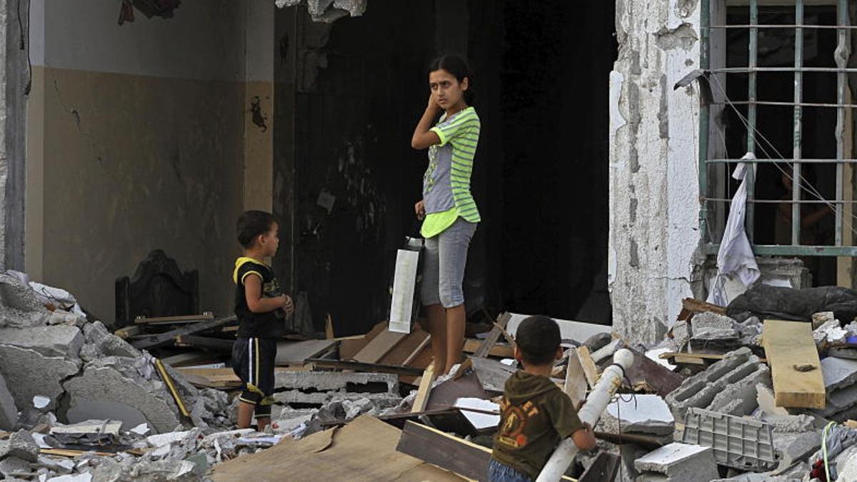 Niños juegan entre los escombros en Gaza.