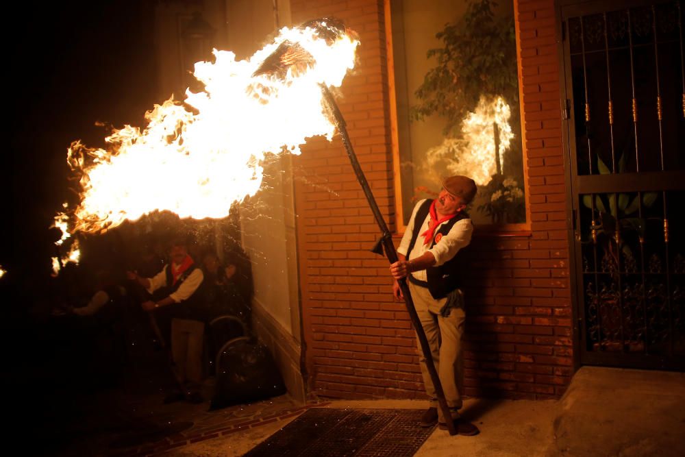 Villagers hold torches during the Divina Pastora ...