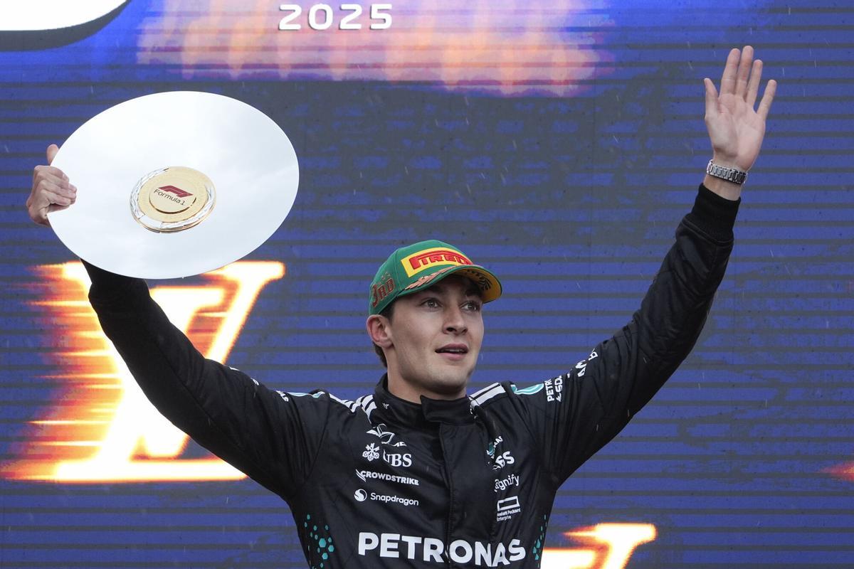 Mercedes driver George Russell of Britain celebrates on the podium following his third place finish at the Australian Formula One Grand Prix at Albert Park, in Melbourne, Australia, Sunday, March 16, 2025. (AP Photo/Asanka Brendon Ratnayake)
