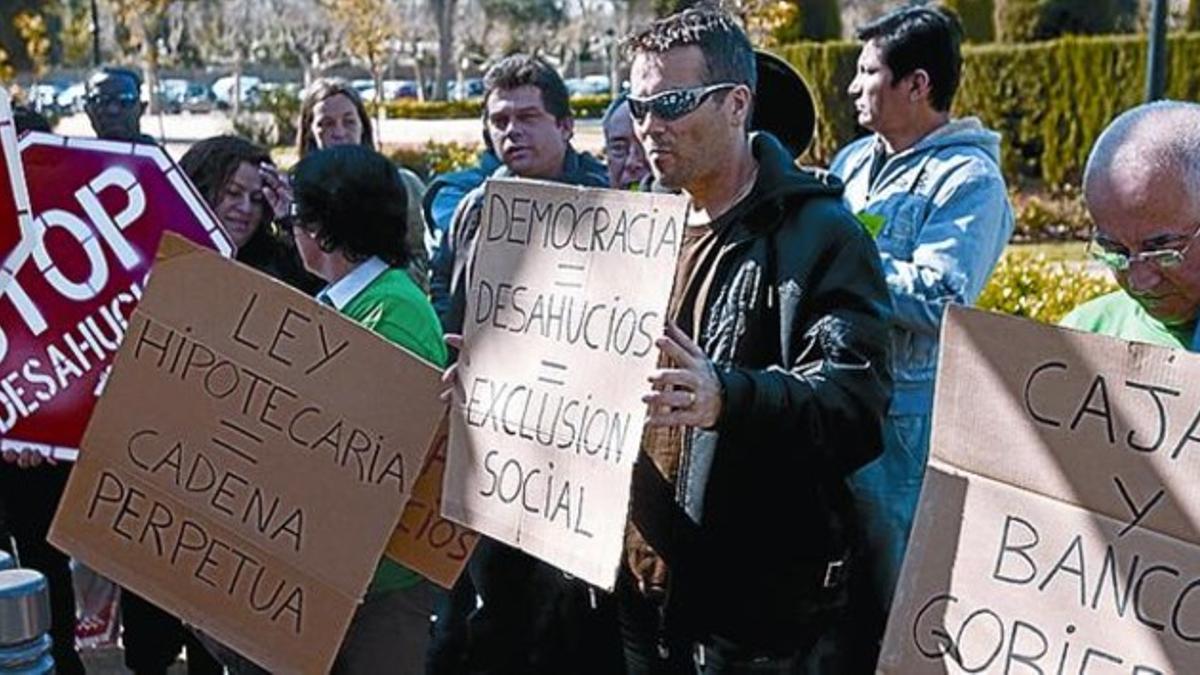 FRENTE AL PARLAMENT 3 Afectados por desahucios protestan ante el Parlament para pedir la modificación de la ley hipotecaria, el 23 de marzo.