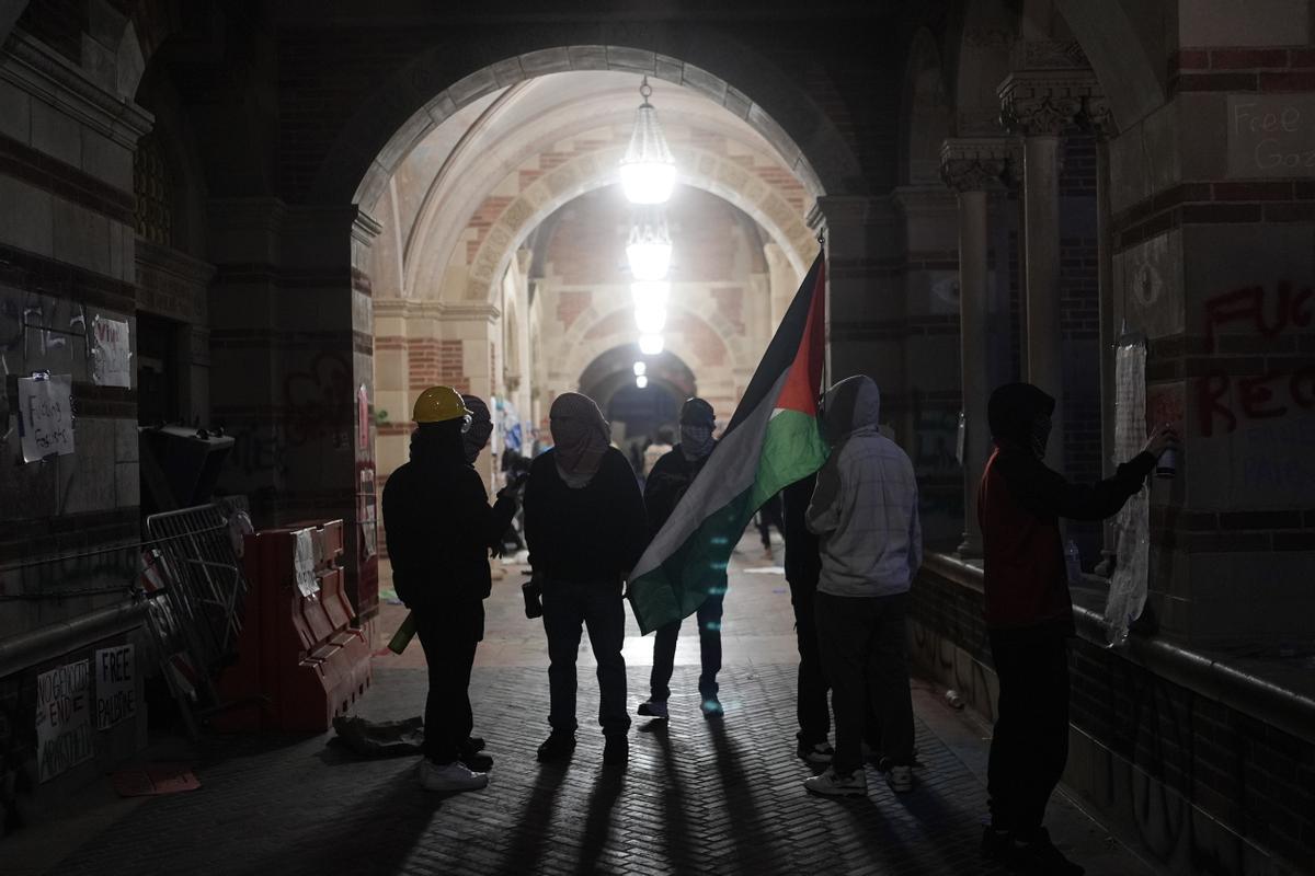 Pro-Palestinian demonstrators stand in a hallway on the UCLA campus Wednesday, May 1, 2024, in Los Angeles. (AP Photo/Jae C. Hong)