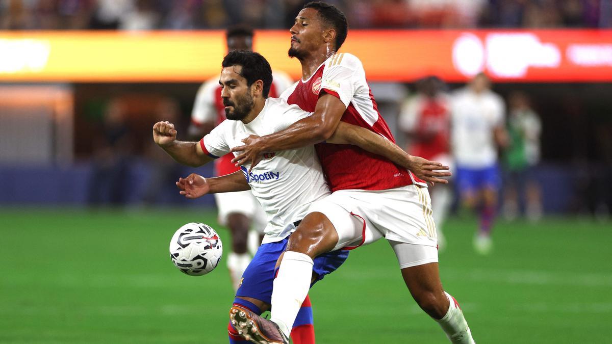 Gündogan aguanta la presión de Saliba en el Arsenal-Barça.