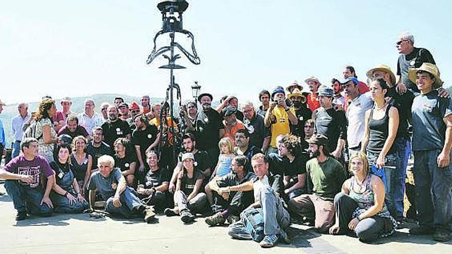 Los ferreiros posan alrededor de la escultura y entre ellos, en el centro, José Naveiras.