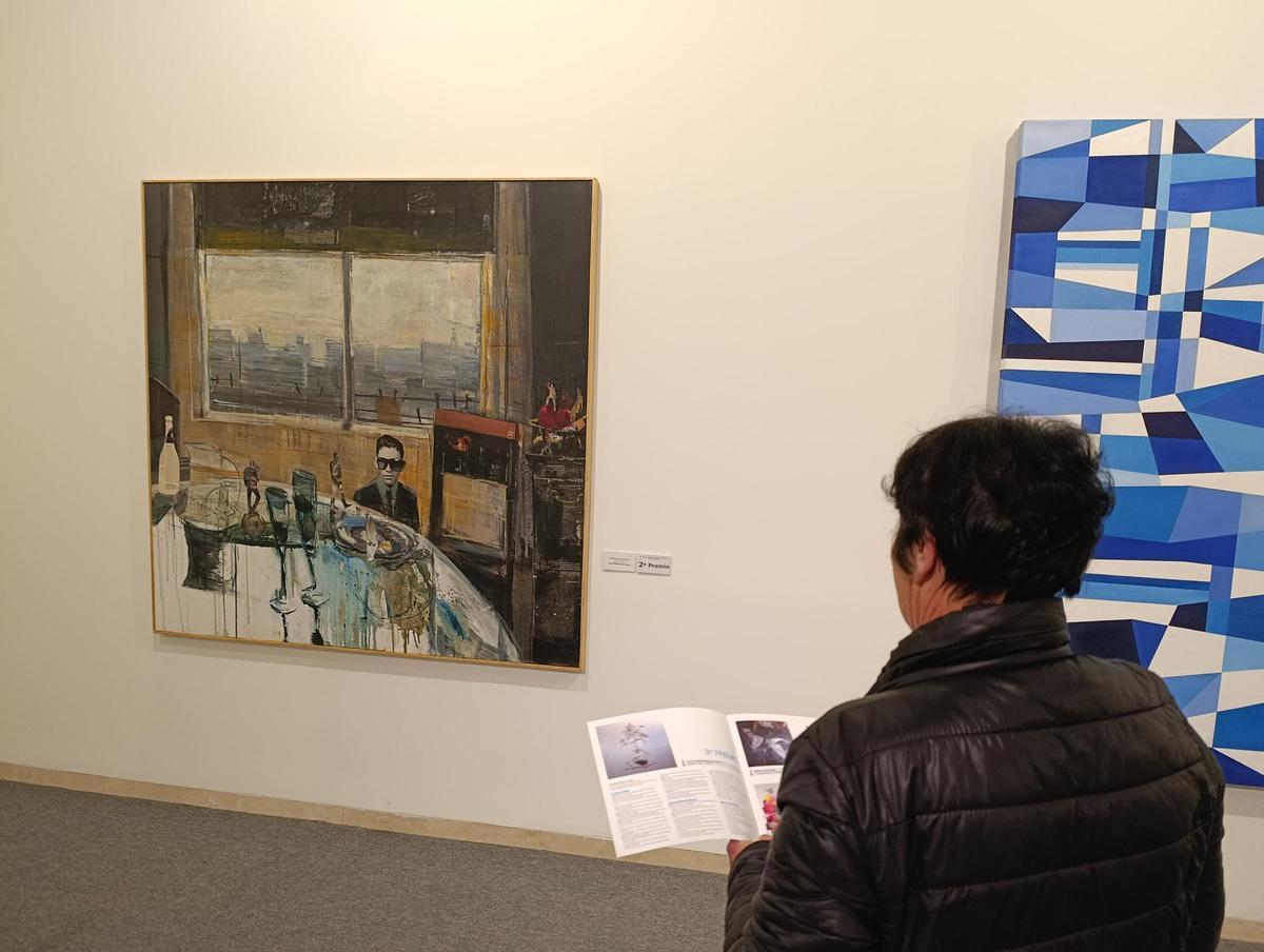 Una visitante observa dos de las obras premiadas.