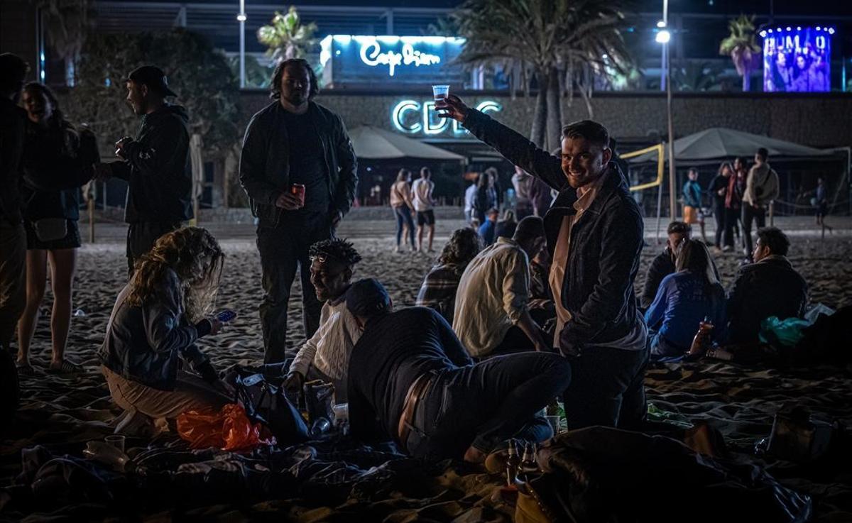 Un grupo de 15 ciudadanos franceses beben y celebran la noche frente a la zona de discotecas del paseo Marítim de Barcelona.