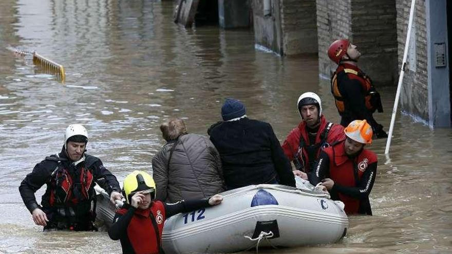 Miembros de la Cruz Roja y de Bomberos rescatan a una pareja en Tudela.