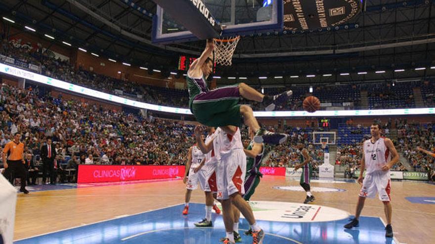 Fran Vázquez, MVP de la jornada, con 25 de valoración, junto al base del Andorra, Thomas Schreiner, se cuelga del aro del Manresa.