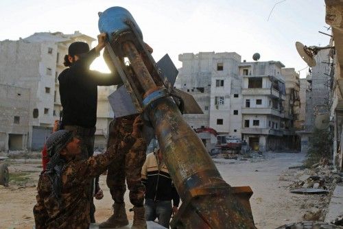 Free Syrian Army fighters prepare a locally-made weapon launcher during clashes with forces loyal to Syria's President Assad in Aleppo