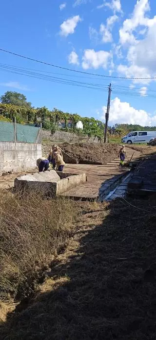 El taller de empleo de A Estrada saca a la luz un lavadero, fuente y caminos perdidos entre la maleza