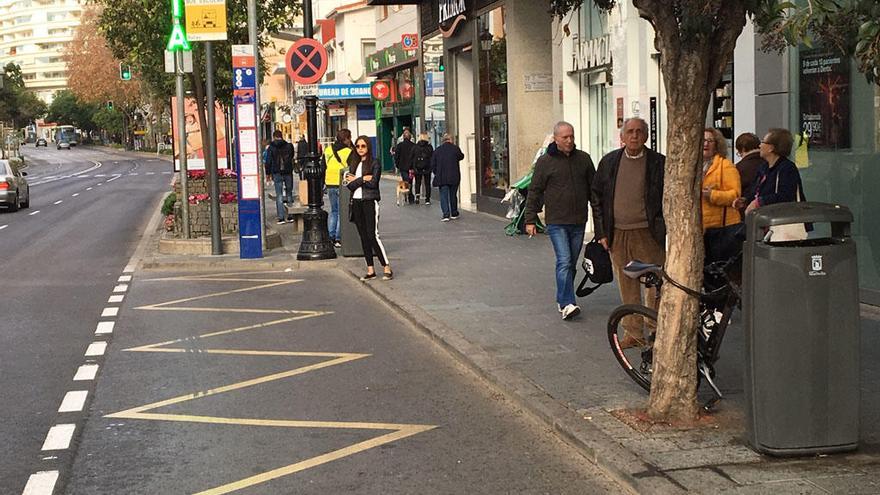 Usuarios esperan al autobús en una de las paradas del centro urbano de Marbella.