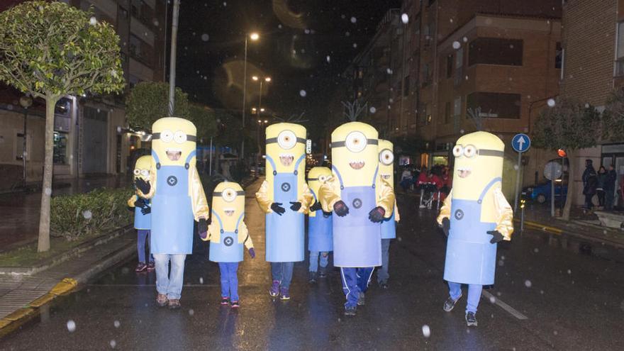 Un grupo de minions dirigiéndose al inicio del desfile bajo la lluvia