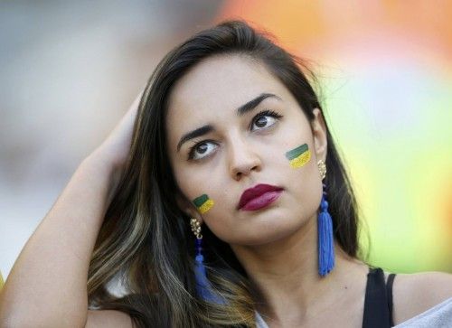 A fan waits for the start of the 2014 World Cup round of 16 game between Brazil and Chile at the Mineirao stadium in Belo Horizonte