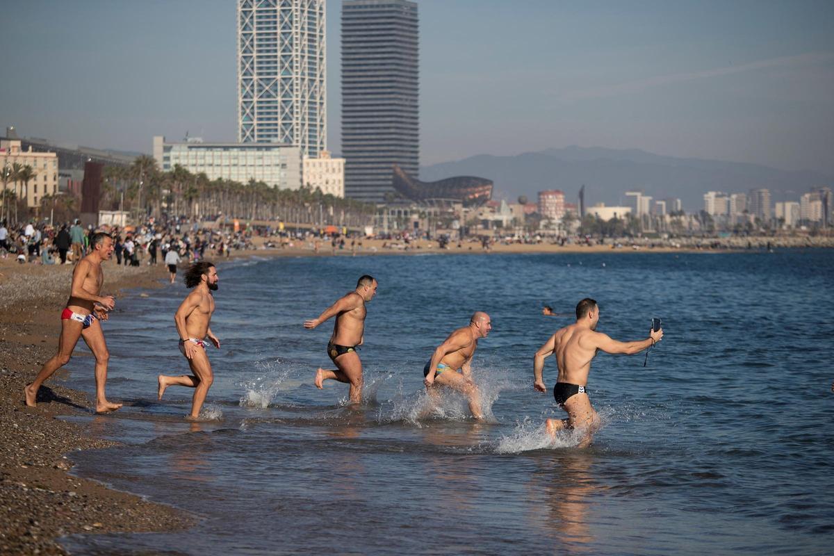 Miles de personas disfrutan de las playas de Barcelona en la mañana del primer día del año que ha despertado con temperaturas suaves.