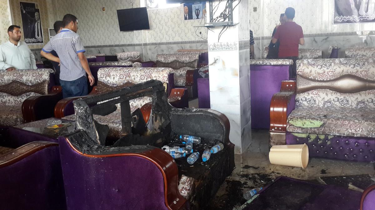 People gather at a cafe after an attack in the predominately Shi'ite Muslim town of Balad