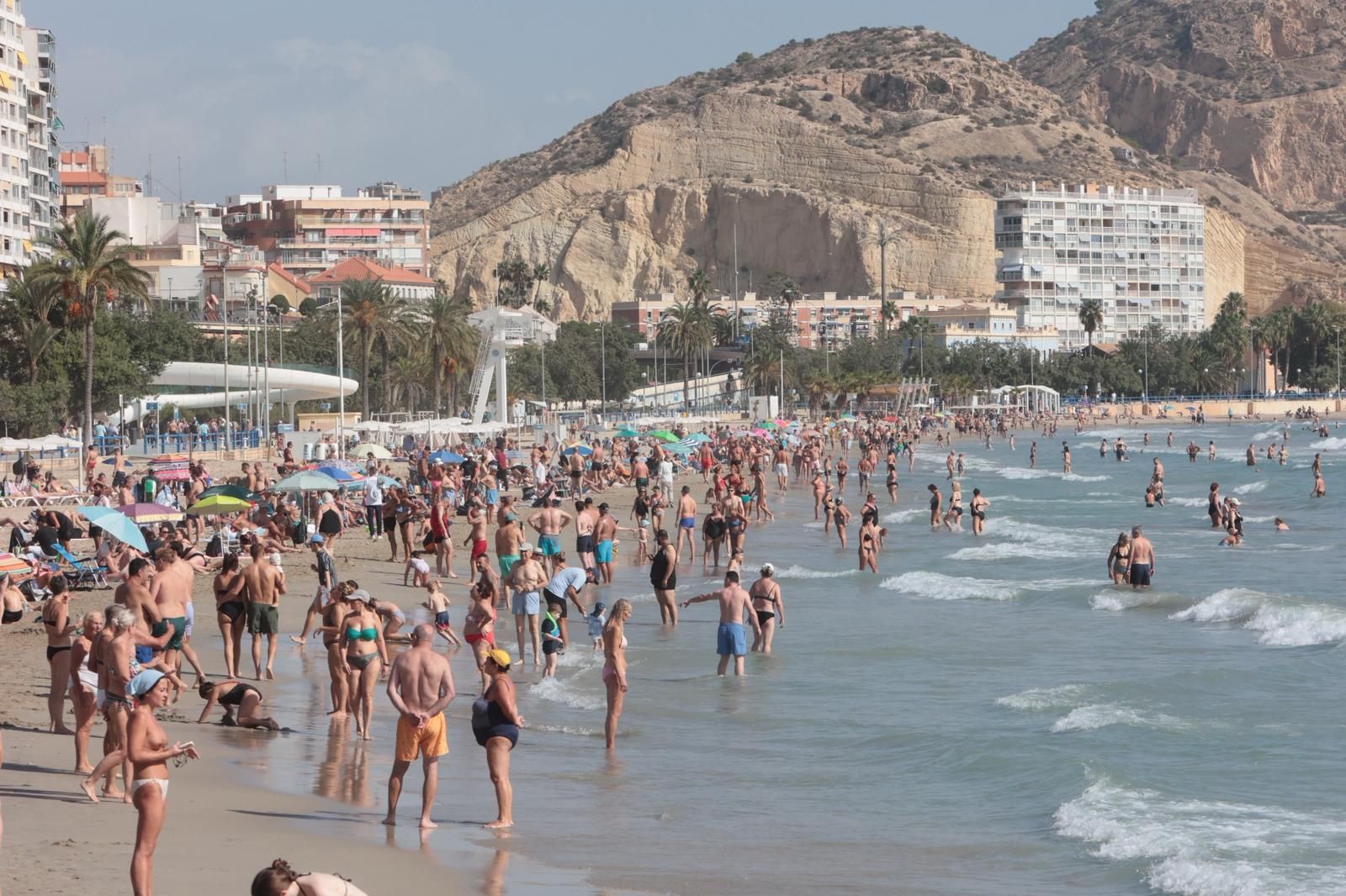 El martes de sol tras la dana Alice llena la playa del Postiguet de Alicante