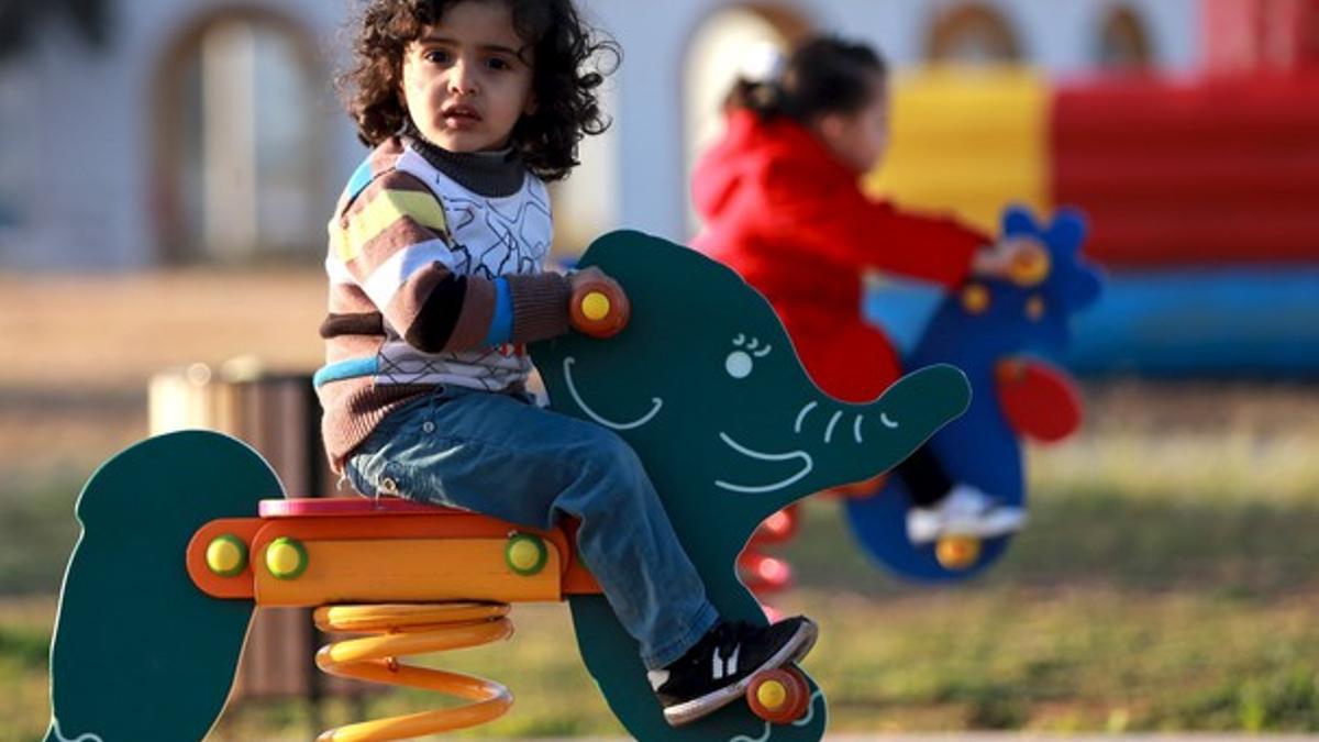 A child plays at a children's playground in Benghazi