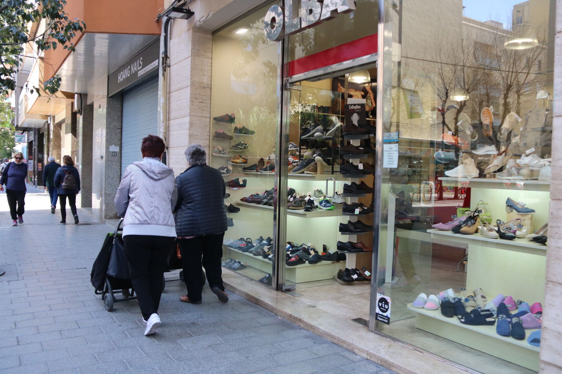 Dos personas pasean por una zona comercial de Vilanova i la Geltrú