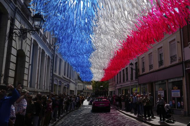 A street is decorated with the colors of the French flag during the third stage of the Tour de France cycling race over 178.3 kilometers (110.8 miles) with start in Valenciennes and finish in Dunkerque, France, Monday, July 7, 2025. (AP Photo/Mosaab Elshamy)