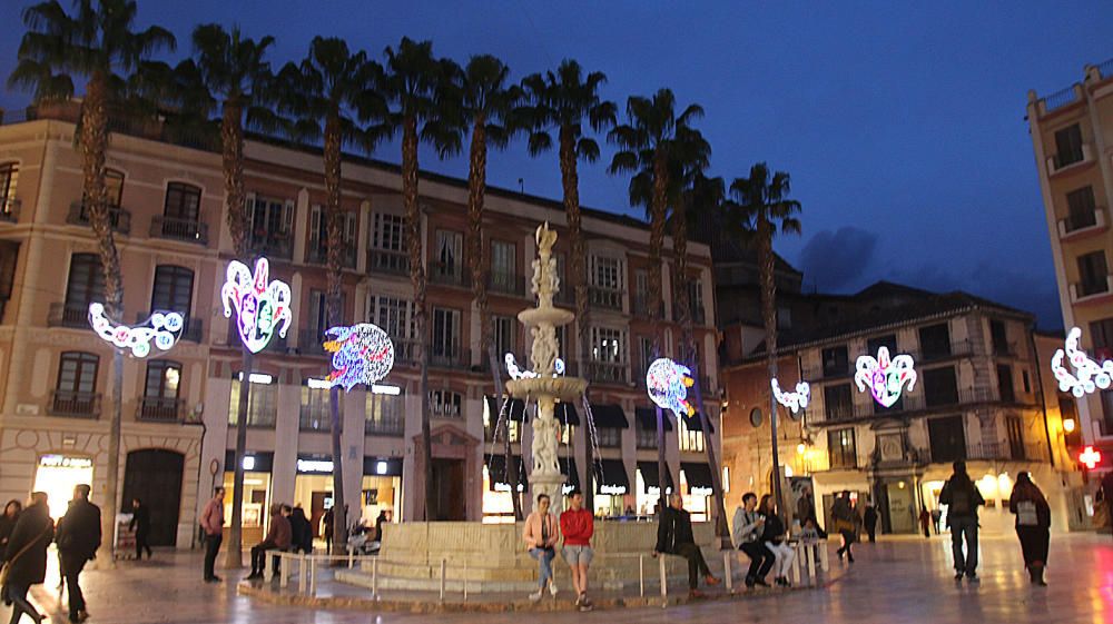 La principal calle del centro de Málaga ya luce los motivos carnavalescos, máscaras y antifaces, con motivo de la Fiesta del Invierno Cálido de la ciudad