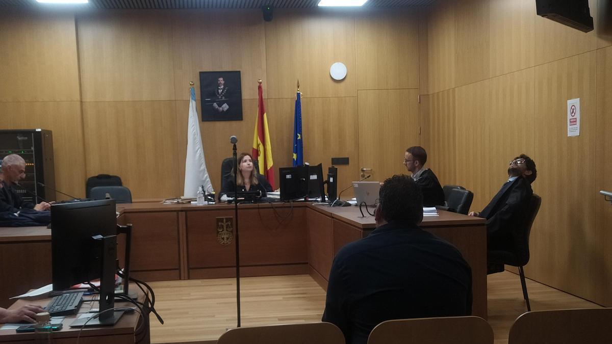 Uno de los acusados en el banquillo, el otro, por videoconferencia, ayer en el Penal.