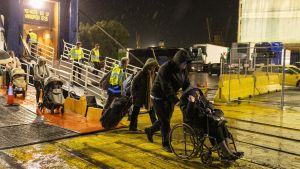 Un grupo de personas desembarca cerca de Atenas tras abandonar en barco la isla de Santorini.