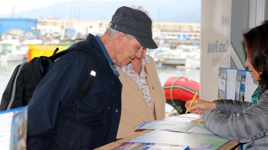 Una parella de turistes parlant amb la informadora del Port de Roses