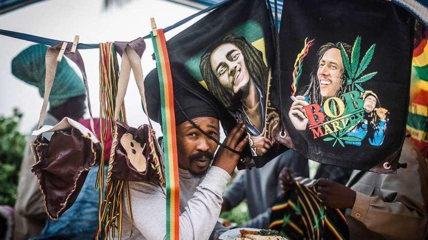 Un hombre vende varias bolsas con la imagen de Bob Marley.