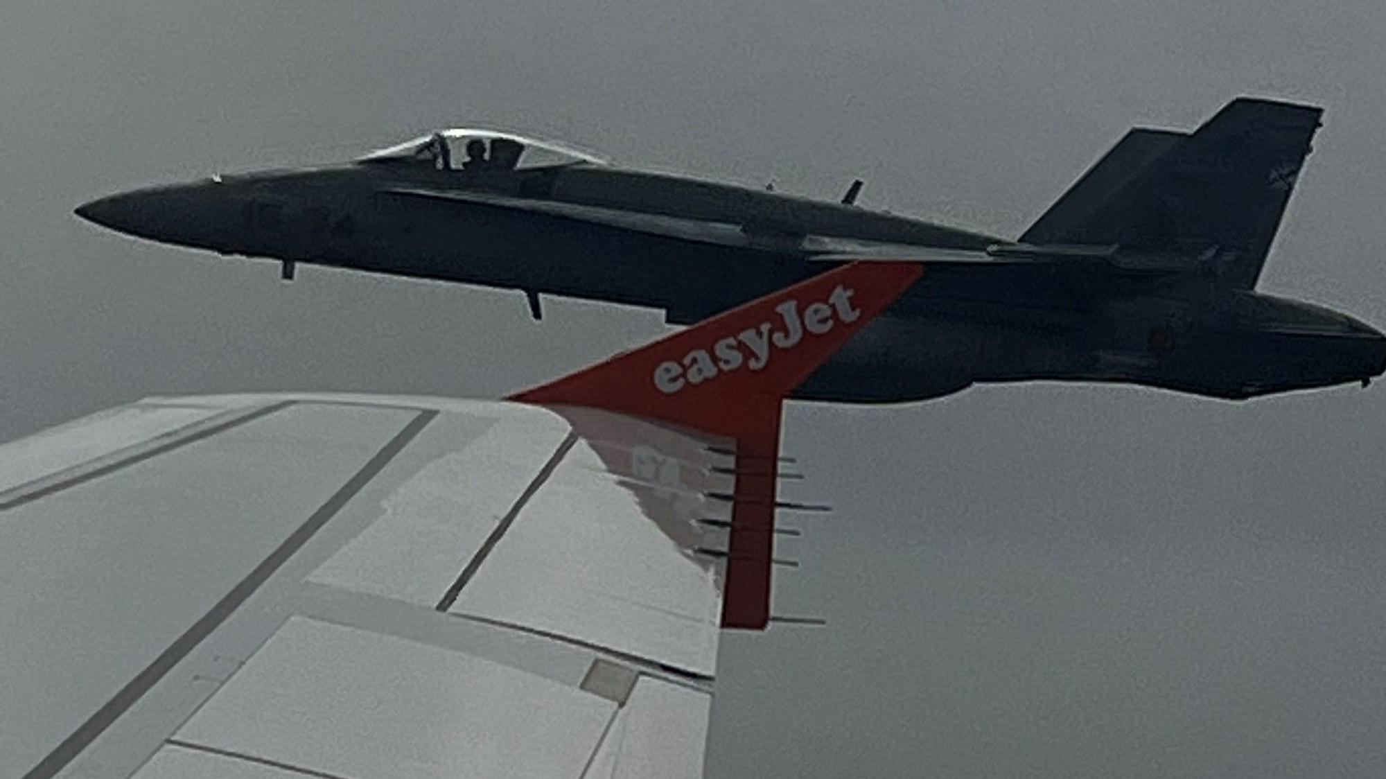 MARCUS TORR Spanish F-18 jet fighter escorts Easyjet plane after teen bomb hoax Spanish F-18 jet fighter, seen through plane window, escorts an Easyjet flight heading from London to the Spanish holiday island of Menorca, after a hoax bomb threat by an 18-year-old British passenger, July 3, 2022. Marcus Torr/via REUTERS ATTENTION EDITORS - THIS IMAGE HAS BEEN SUPPLIED BY A THIRD PARTY. MANDATORY CREDIT. NO RESALES. NO ARCHIVES