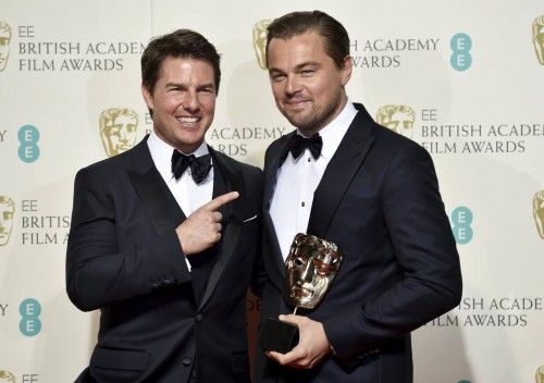 Leonardo DiCaprio holds his award for best leading actor as he stands with presenter Tom Cruise at the British Academy of Film and Television Arts (BAFTA) Awards at the Royal Opera House in London