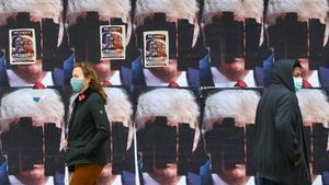 zentauroepp55669500 people walk past u s  president donald trump s posters that 201030194610