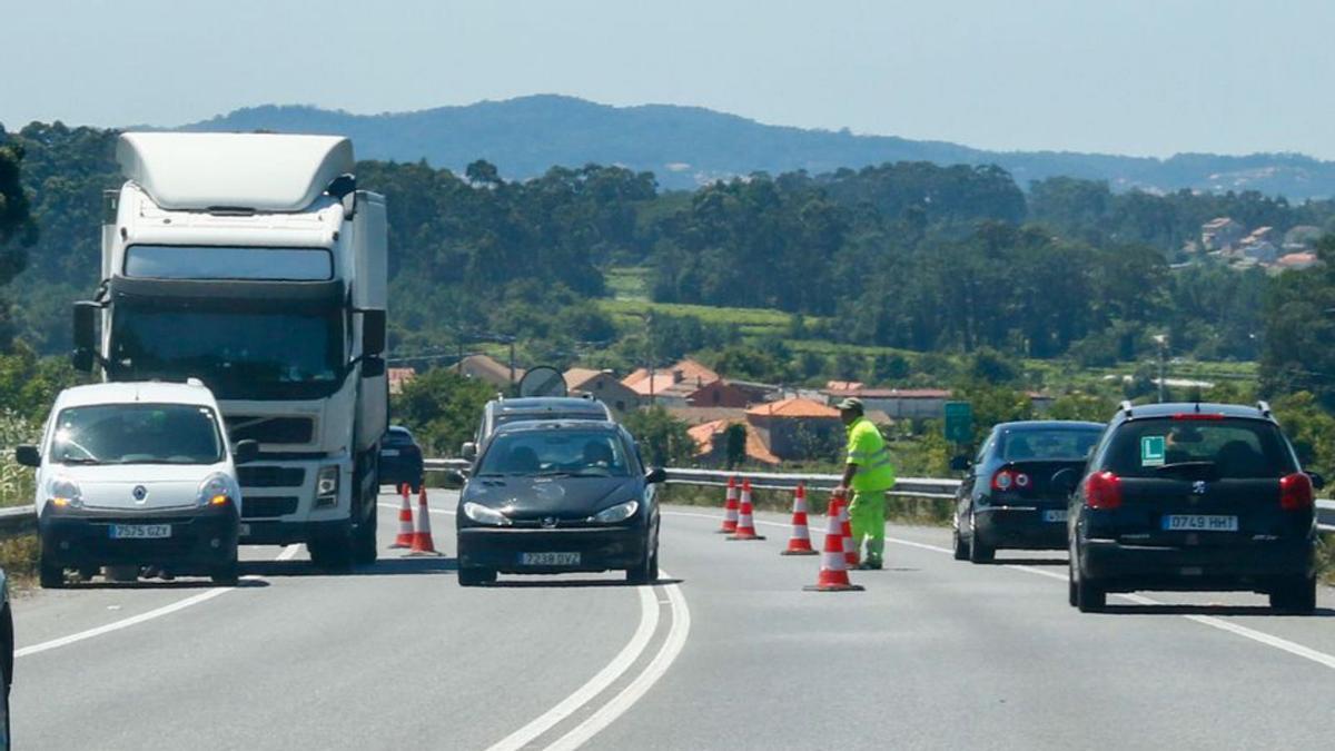 Camión averiado, con los vehículos circulando por los carriles provisionales