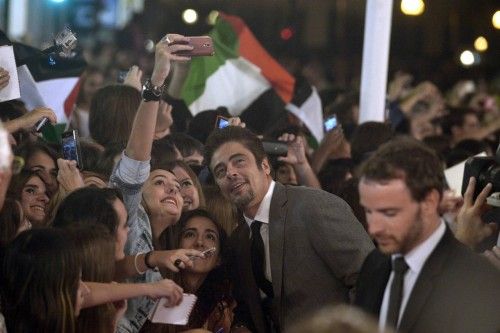 Puerto Rican actor Del Toro takes pictures with fans on arrival to receive his Donostia Award for career achievement at the San Sebastian Film Festival