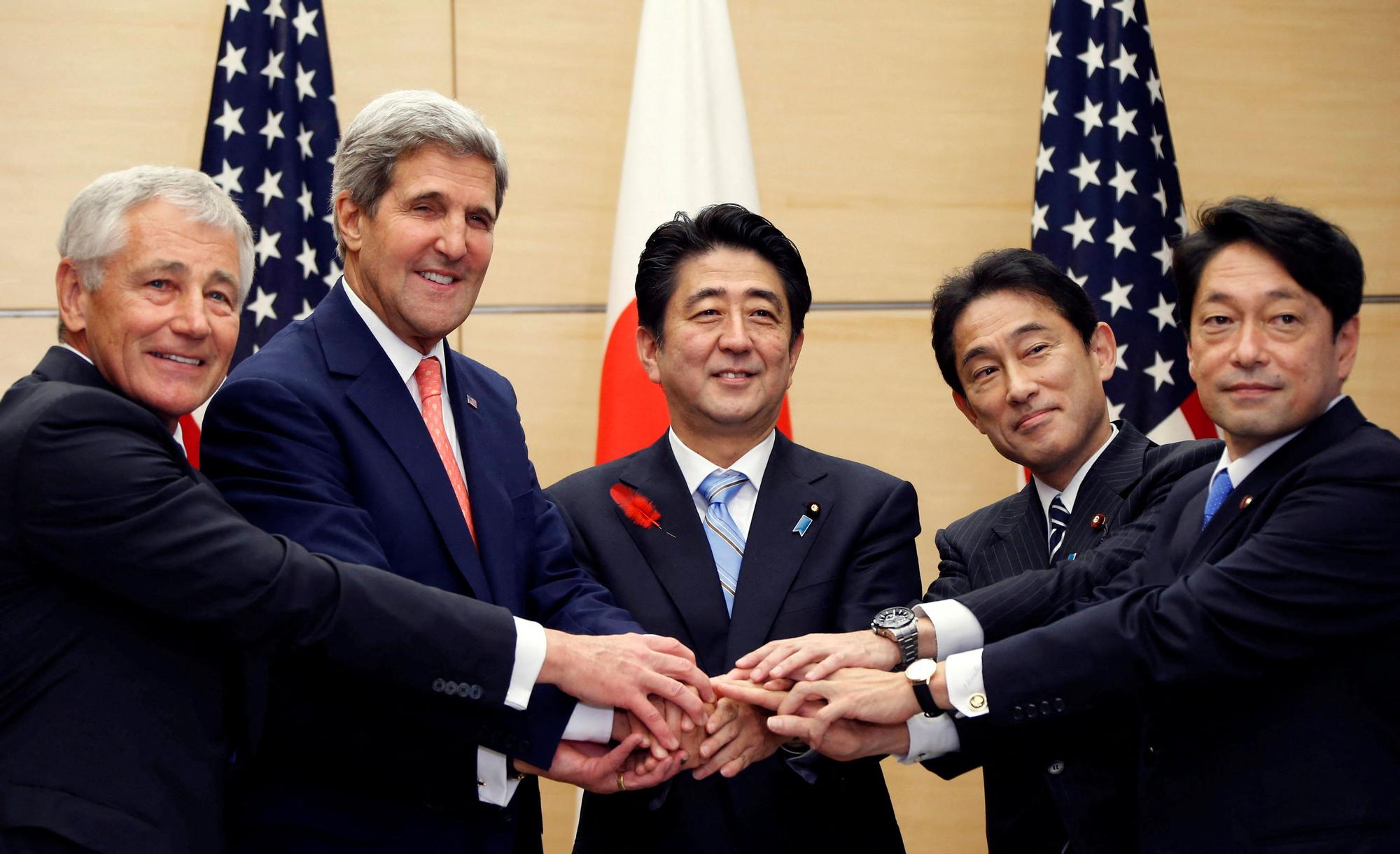 FILE PHOTO: U.S. Defense Secretary Hagel, U.S. Secretary of State Kerry, Japan's PM Abe, Japan's Foreign Minister Kishida and Japan's Defense Minister Onodera pose for photos during their meeting in Tokyo