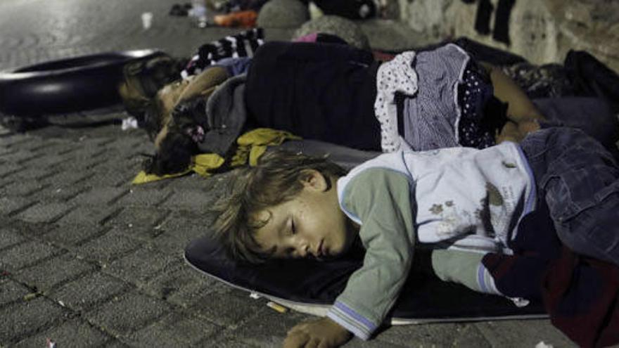 Inmigrantes sirios duermen en el puerto de Kos.