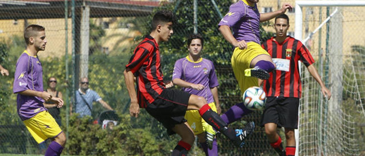 El jugador teldense trata de obstaculizar el despeje del futbolista del Unión Viera.