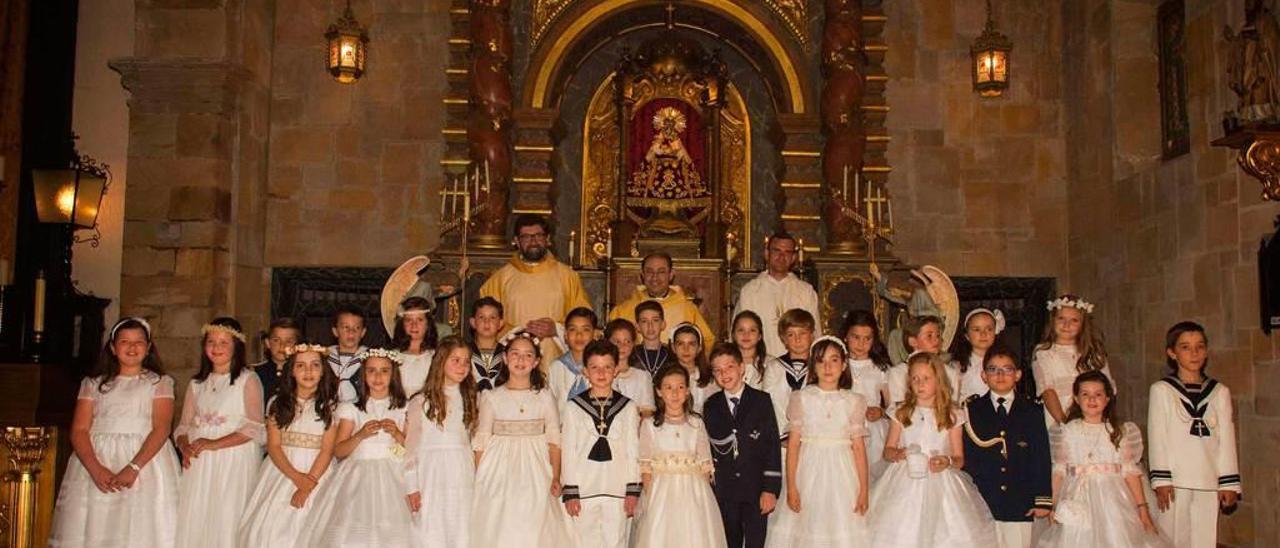 Foto de grupo de los niños de primera comunión en Villaviciosa; detrás, por la izquierda, Juan Hevia Fisas, párroco de Pola de Siero; el cura de Villaviciosa, Jorge Cabal, y el padre Iyan, sacerdote de Bielorrusia.