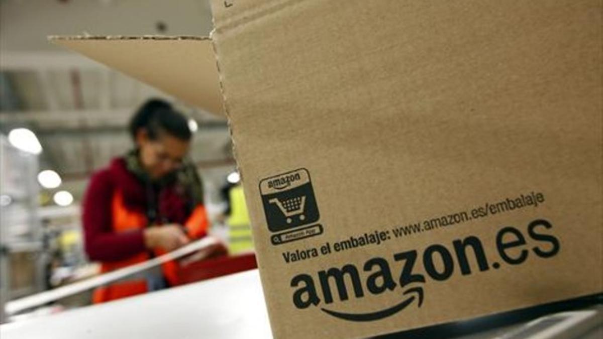 Un trabajador empaqueta un pedido de Amazon en una de los almacenes logísticos de la multinacional.