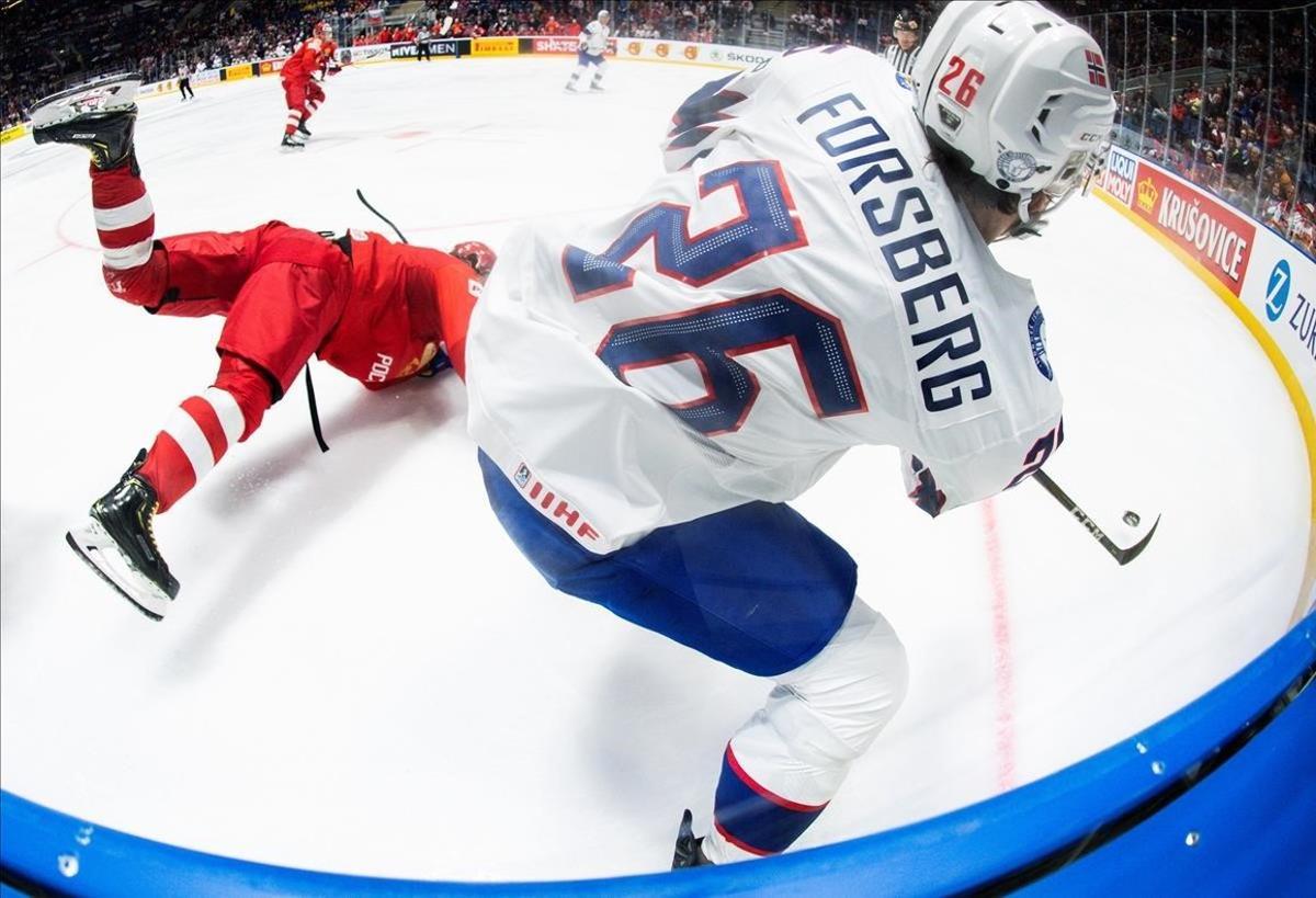 El jugador ruso Serguéi Plotnikov en acción ante el noruego Martin Forsberg durante el partido del grupo B del Campeonato del Mundo de Hockey sobre hielo disputado en el Ondrej Nepela Arena de Bratislava (Eslovaquia).