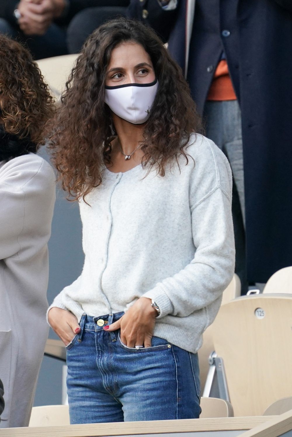 Xisca Perelló con jeans clásicos y una chaqueta de punto gris viendo el partido de Rafa Nadal en Roland Garros