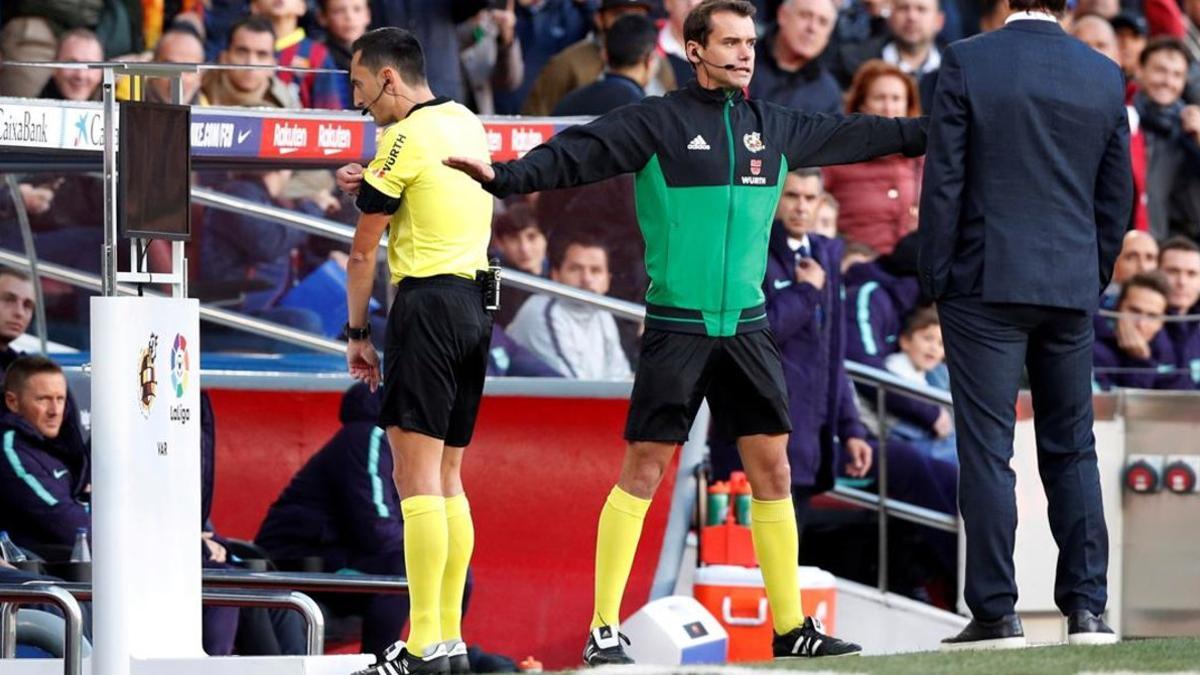 El árbitro Sánchez Martínez revisa una jugada en el monitor durante el Barça-Madrid de la Liga 18-19.