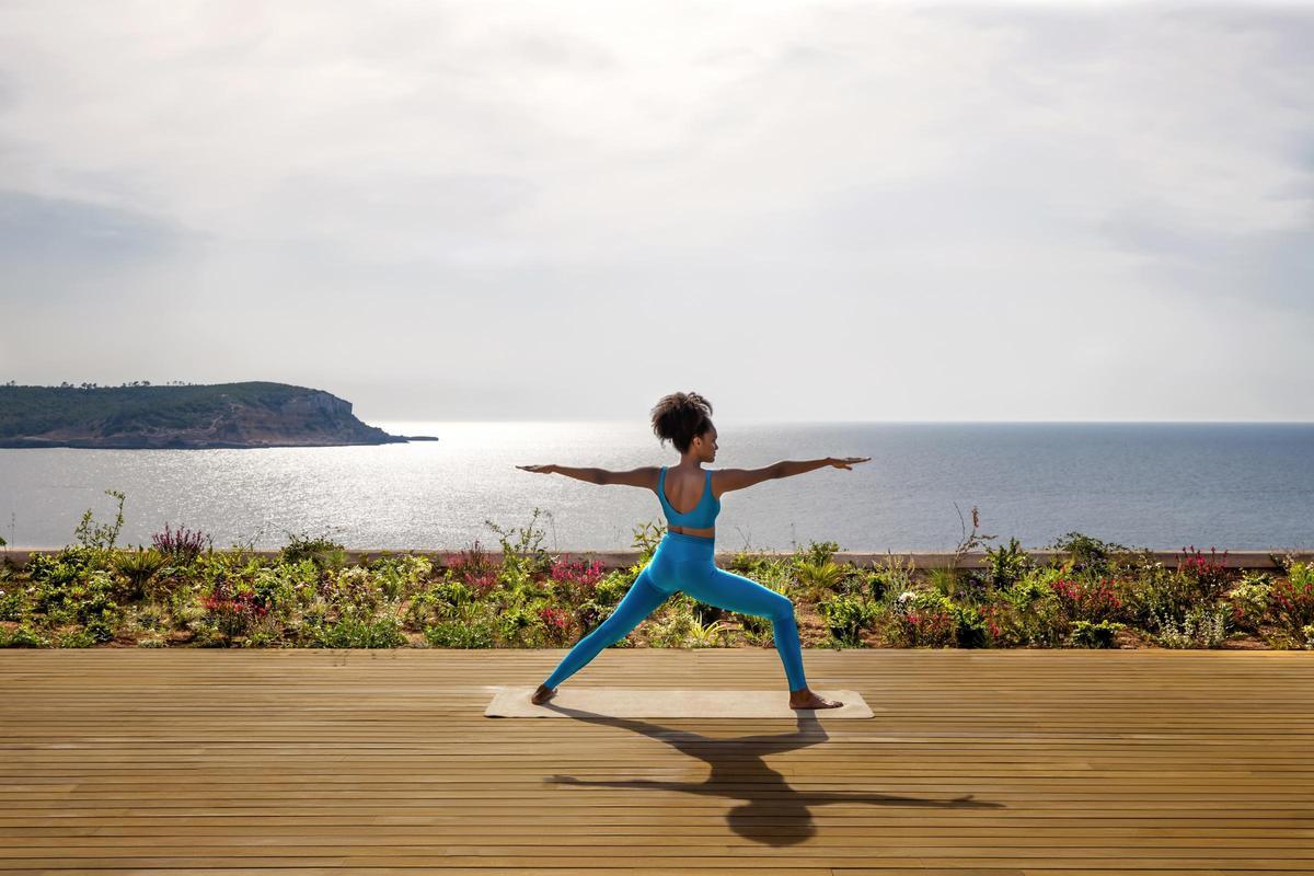 Una de las clases de yoga con vistas a la bahia de Cala Xarraca en Six Senses Ibiza.